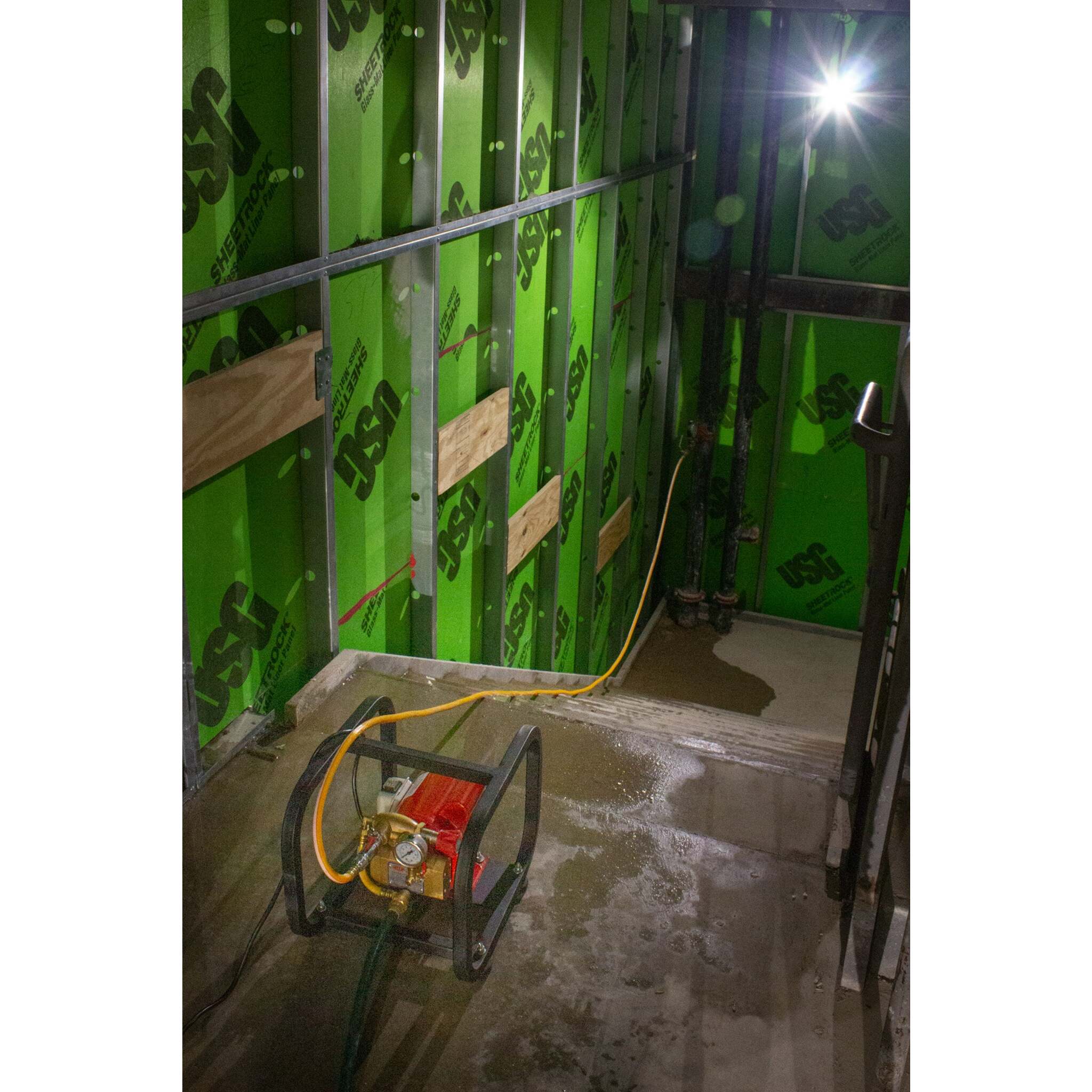 Hydrostatic test pump set up for water pressure testing indoors