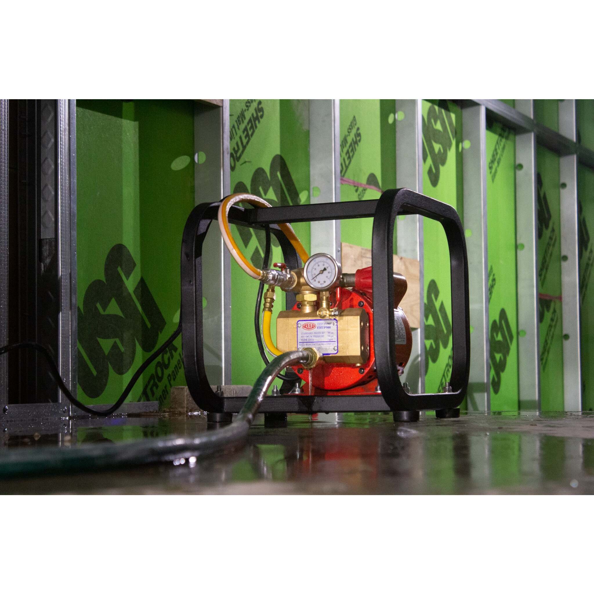 REED hydrostatic test pump set up for indoor water pressure testing
