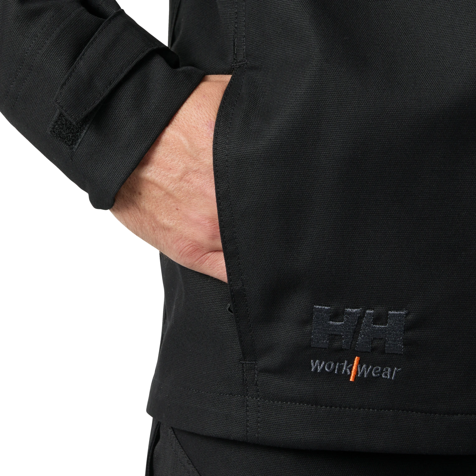 Hand inside Helly Hansen Oxford black work jacket side pocket