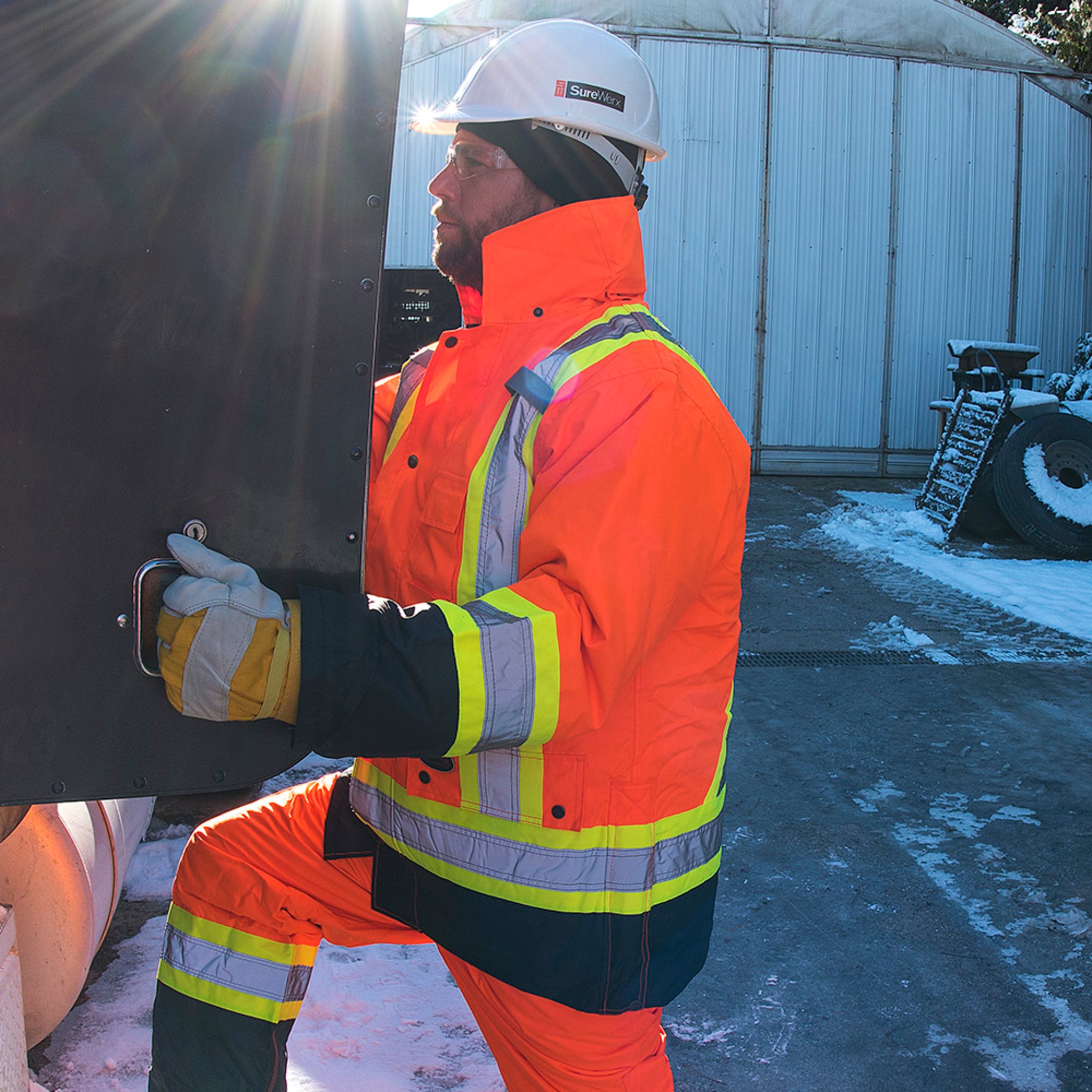 Worker wearing Pioneer orange hi-vis winter safety parka