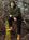 Man wearing Stanfield's 1329 heavy weight wool henley hoodie in green, sitting on a log in a winter forest
